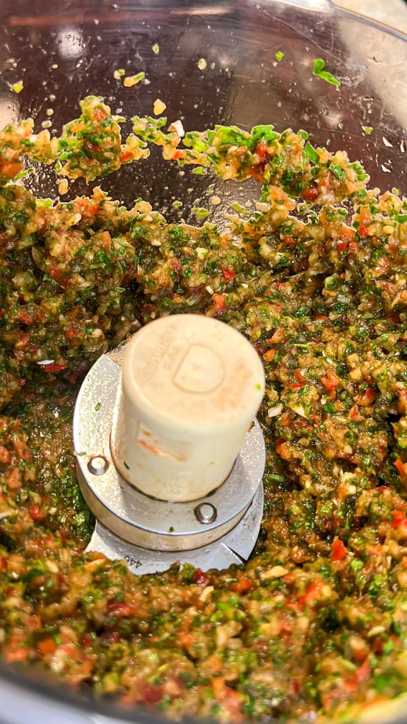 The veggie mixture for kafta kebab in a food processor