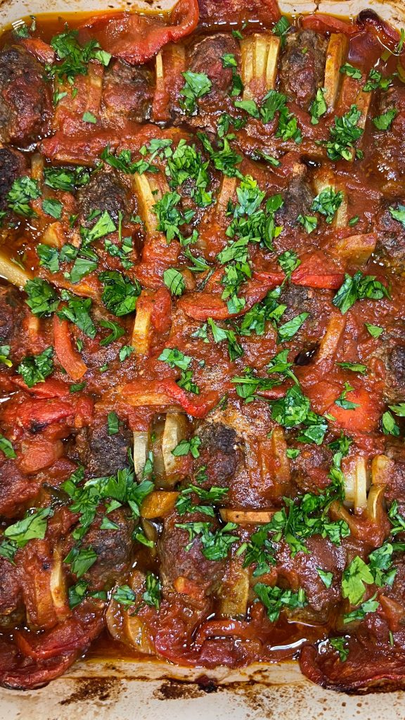 kafta bil sanieh in a baking dish