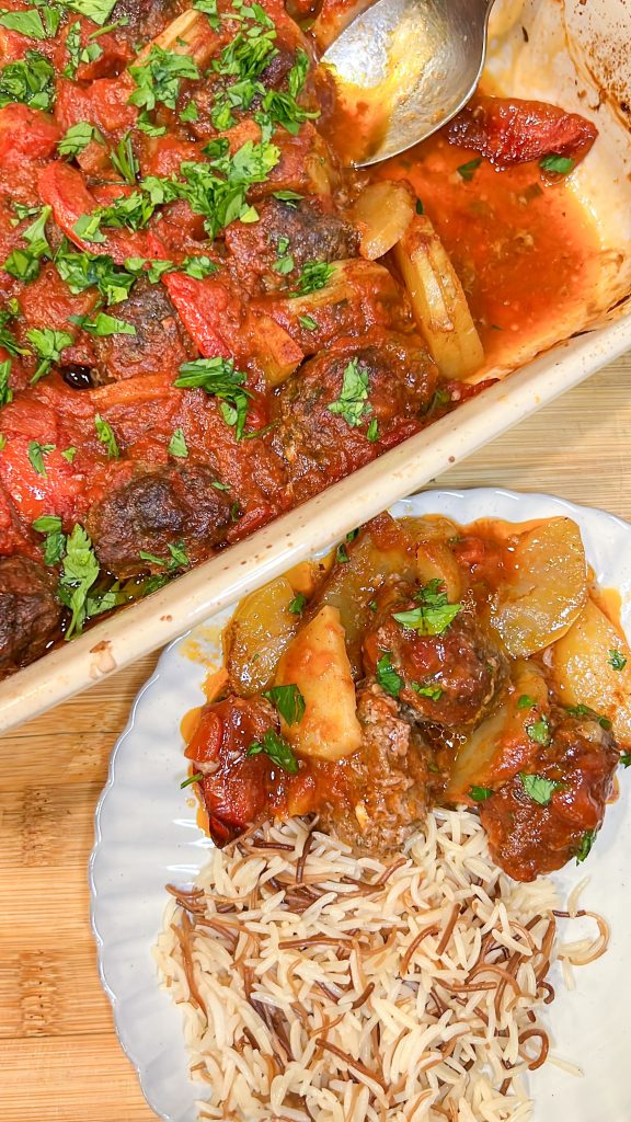 Kafta bil sanieh being plated next to Arab rice pilaf